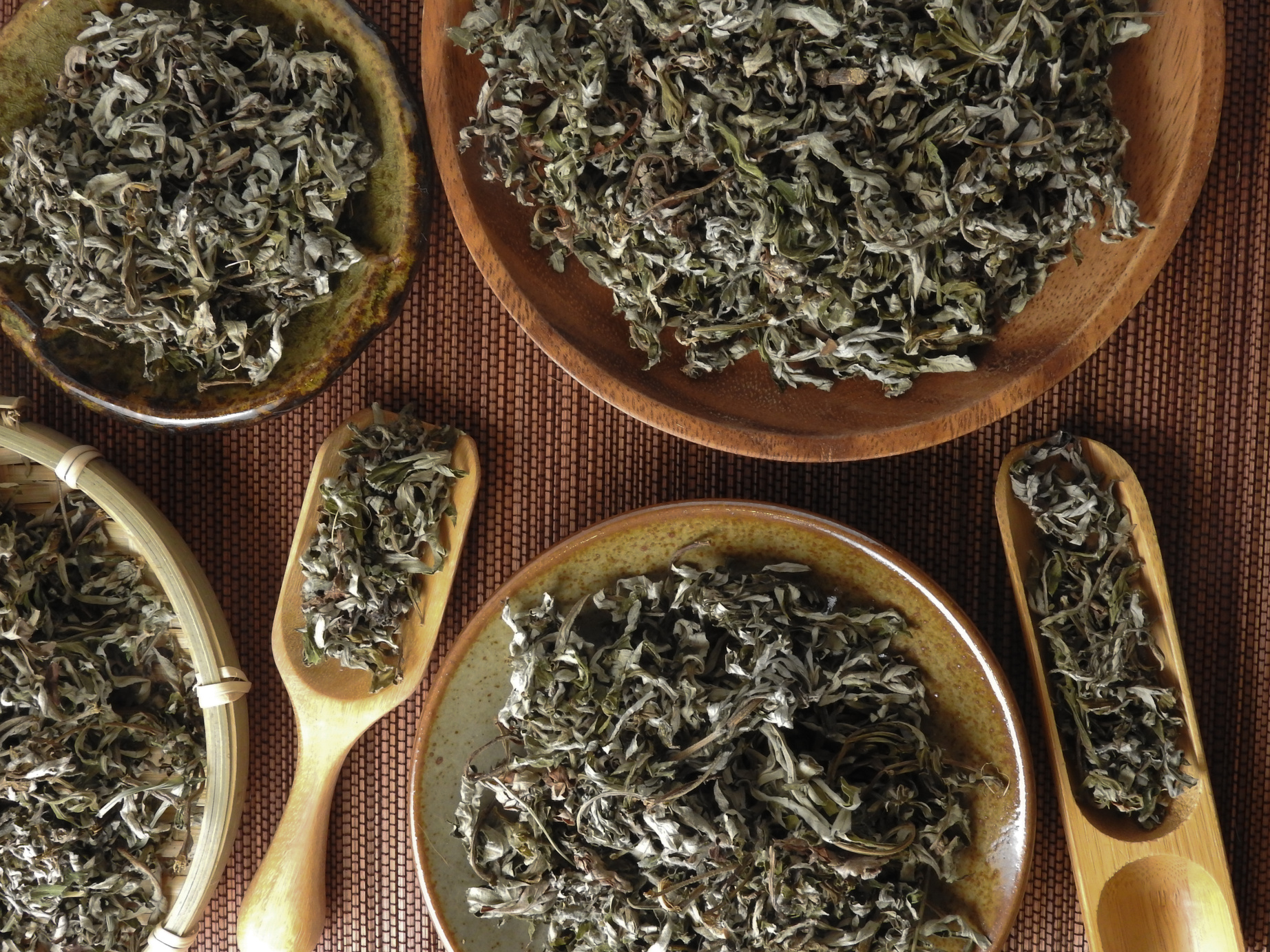 Top View of Dry Mugwort on Wooden Plates and Spoons